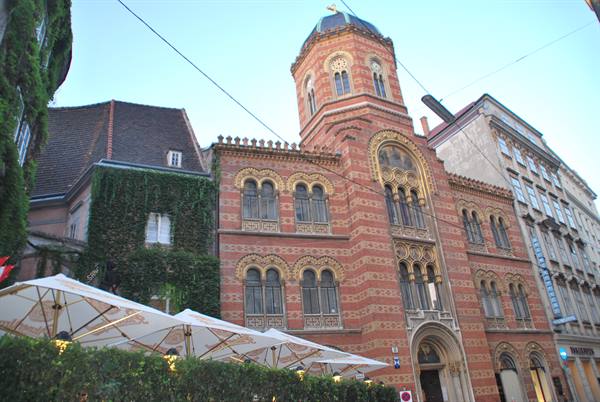 Greek Orthodox church in Vienna, decorated bricks with café umbrellas below