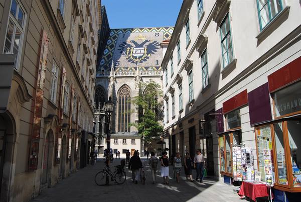 Tourists walk along the street toward St. Stephen's Cathedral in Vienna