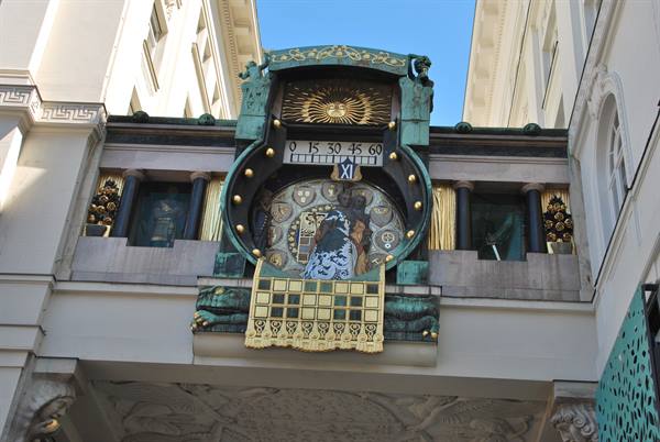 Vienna's Anker Clock, oxidized copper and golden mosaics between two buildings