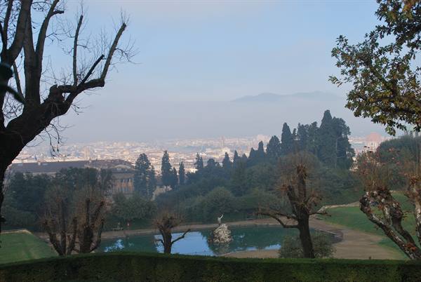 Statue fountain in a pond at Boboli Gardens, Florence hazy in the background