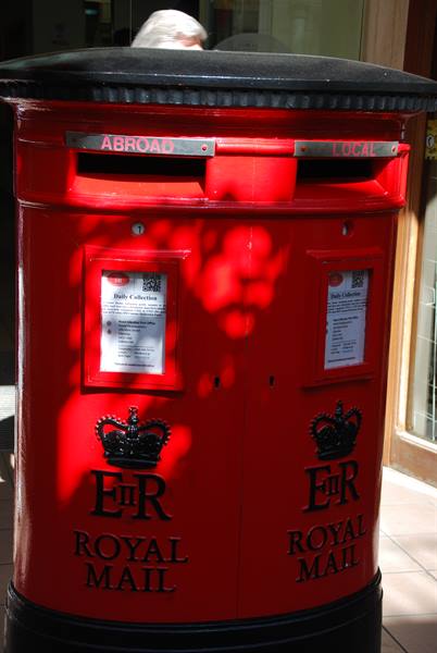 Double red Royal Mail post box with Abroad and Local slots