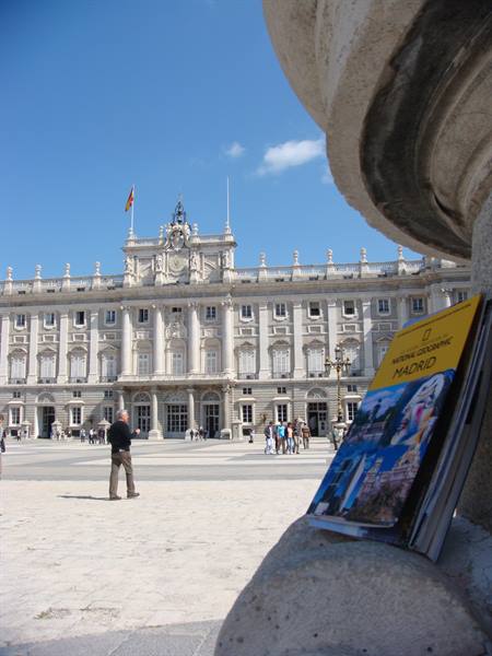 Madrid guidebook on a stone fountain in front of the Royal Palace