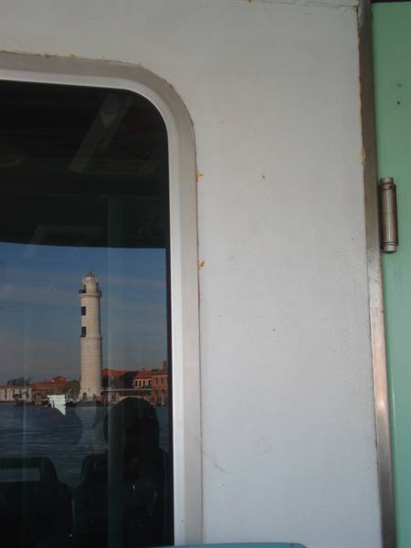 Lighthouse seen through a ferry window, daytime light