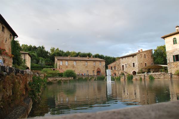Bagno Vignoni, steaming thermal pool surrounded by medieval stone buildings