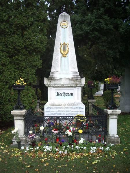 Beethoven's grave at Vienna's Zentralfriedhof, marble obelisk with golden lyre and flowers