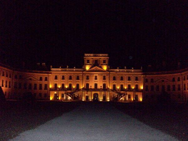 Esterházy Palace at Fertőd lit up at night, golden baroque facade
