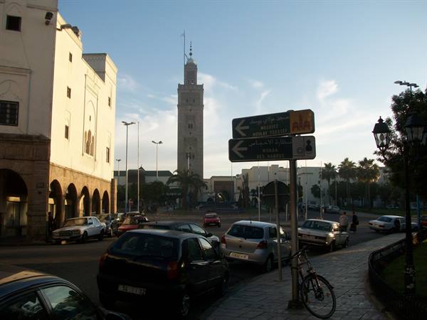Hassan II Mosque minaret rising above buildings and traffic in Casablanca