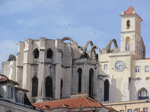 The Gothic ruins of Convento do Carmo with bell tower and clock in Lisbon