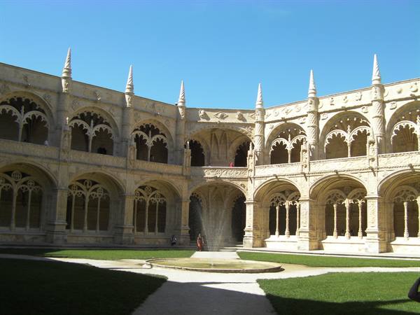 Cloister of the Jerónimos Monastery in Lisbon, fountain in the courtyard, sunlight