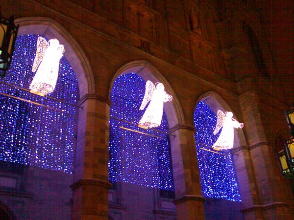 Illuminated angels hang between the arches of Vienna's town hall at Christmas