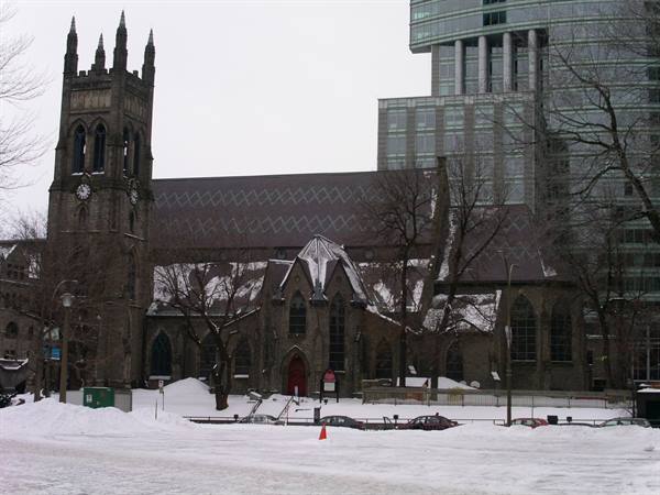 Christ Church Cathedral in Montreal, dark stone and snow among skyscrapers