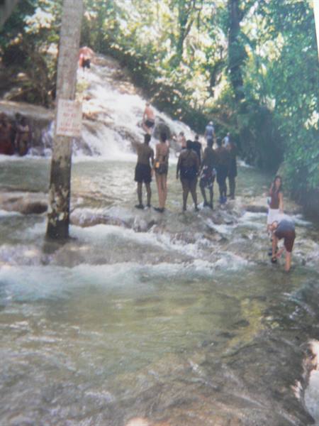 Tourists climbing Dunn's River Falls, Jamaica, on limestone rocks