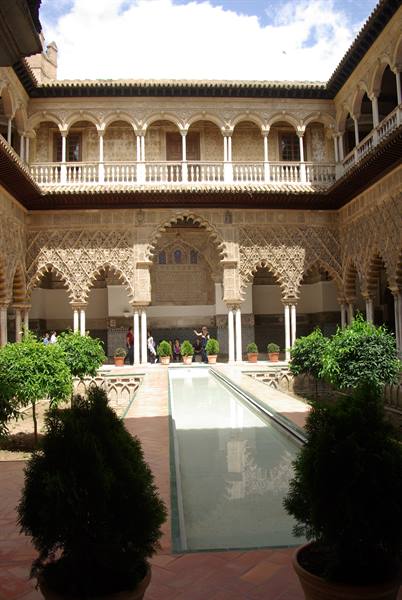 Mudéjar courtyard with carved arches and reflecting pool, Alcázar of Seville
