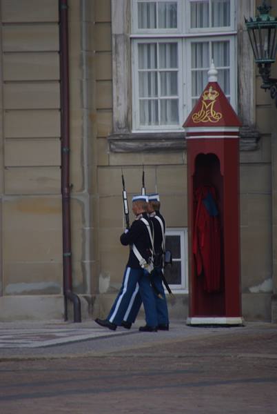 Royal guards marching with rifles past the red sentry box at Amalienborg