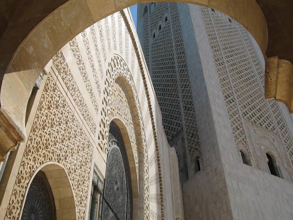 Carved stone arch and minaret of Hassan II Mosque in Casablanca
