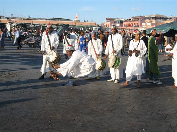 Musicians in white with drums performing in Jemaa el-Fna square, Marrakech