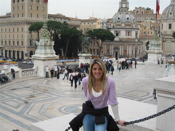 Smiling tourist on the steps of Piazza del Campidoglio in Rome