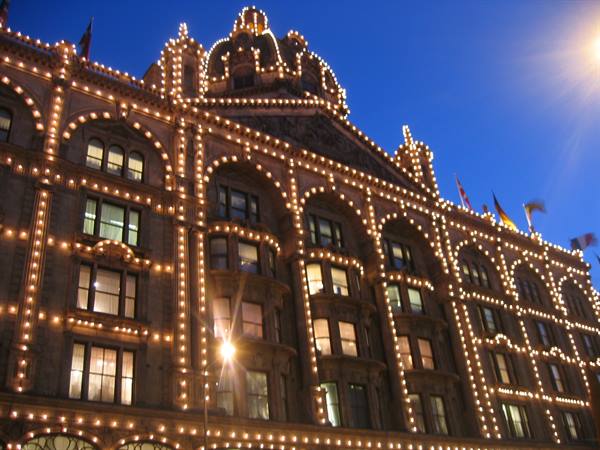 Harrods facade in London illuminated by thousands of light bulbs at dusk