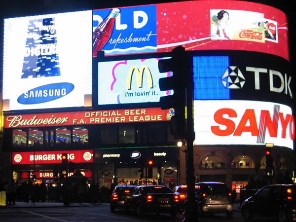 Piccadilly Circus at night: glowing McDonald's and Coca-Cola signs, stopped traffic