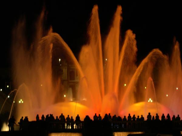 Magic Fountain of Montjuïc: orange illuminated water jets, crowd silhouetted at night