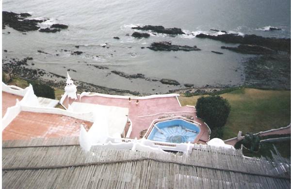 White terraces of Casapueblo with round pool above the ocean