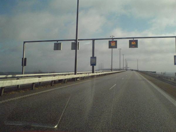 Motorway on the Øresund Bridge, orange overhead signs above the lanes