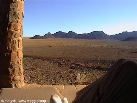 Stone pillar and terrace facing the desert with dark mountains