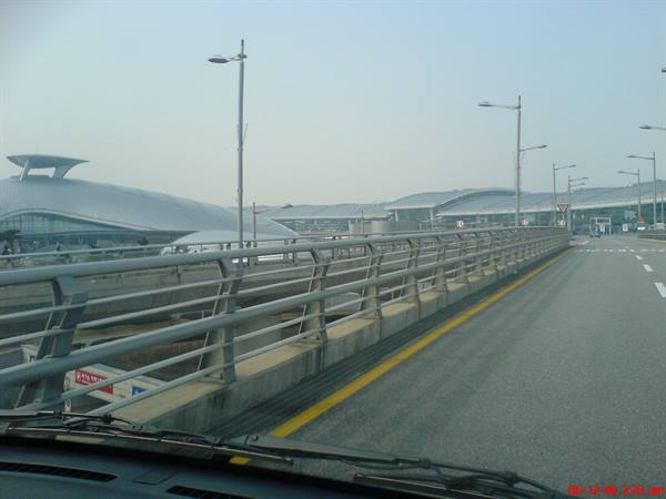 Airport access road toward Incheon terminal seen through car windshield