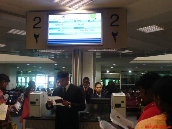 Airline staff checking passports at airport check-in counter 2