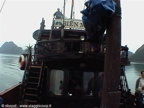 Wooden junk boat in Ha Long Bay, Bien sign, grey sky, calm water
