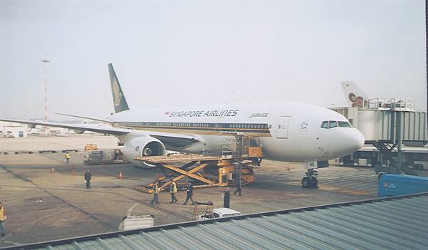 Singapore Airlines Boeing at the airport, ground crew loading luggage with lift platform