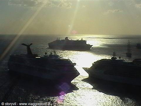 Cruise ships anchored in the bay at sunset, golden light on the sea