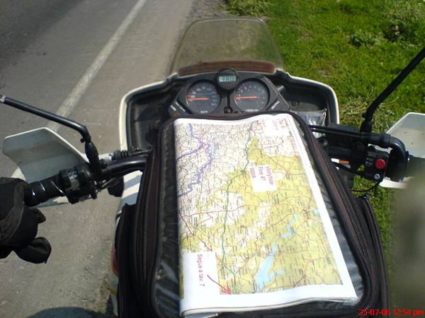 Motorcycle tankbag map with routes and a lake marked, stopped by the road