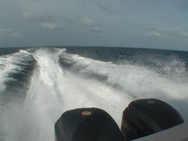 White foam wake behind two Yamaha outboard motors in open sea