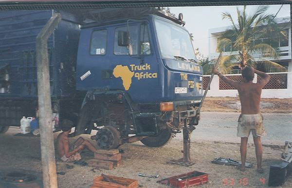 Blue Leyland Truck Africa lorry being repaired, man raising tools