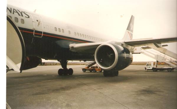 British Airways Boeing parked on tarmac with engine and boarding stairs visible