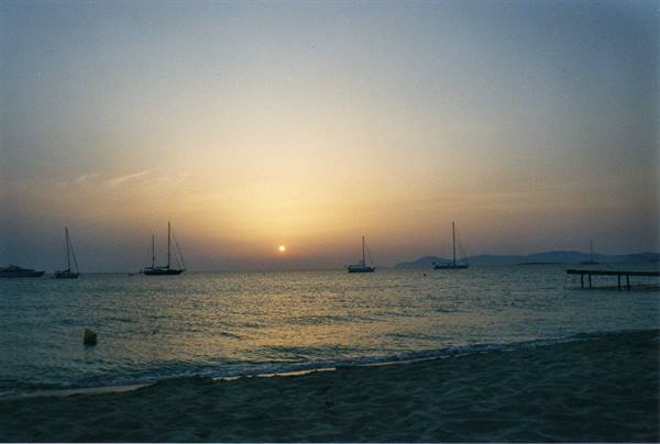 Sailboats anchored off San Antonio Abad beach at sunset, Ibiza