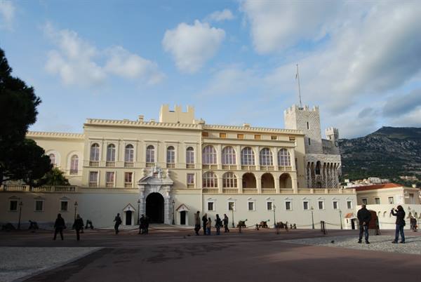 Tourists stroll across the square in front of the Prince's Palace of Monaco