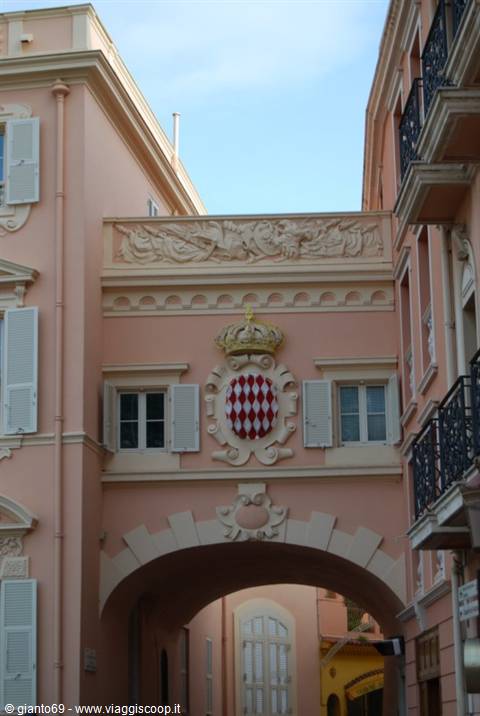 Pink archway bearing the crowned Grimaldi coat of arms in Monaco