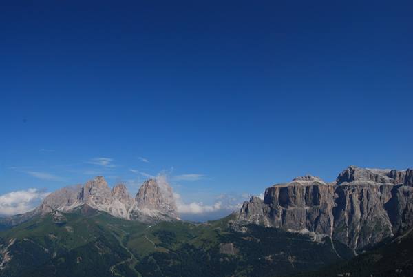 Sella group and Langkofel, Dolomite rock walls under blue sky with clouds