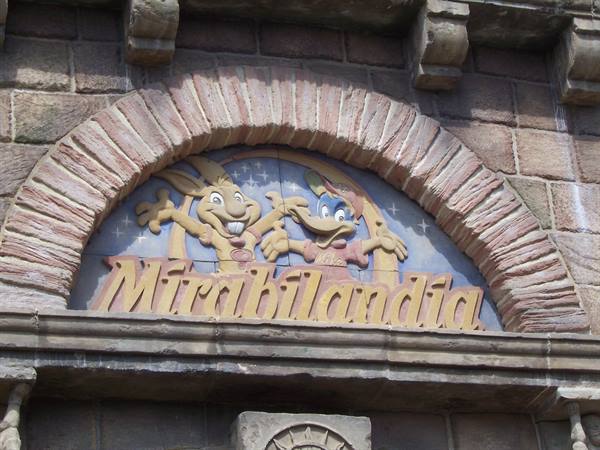 Mirabilandia sign with carved mascots on brick arch, daylight