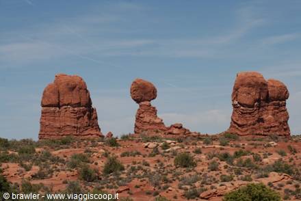 Balanced Rock at Arches National Park, red sandstone formations among desert shrubs
