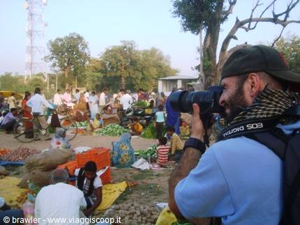 Photographer with Canon lens shooting a lively outdoor vegetable market