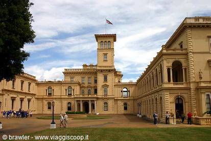 Osborne House: yellow palace with flag tower and visitors in the courtyard