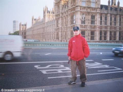 Boy in red jacket on the bridge in front of Westminster Palace