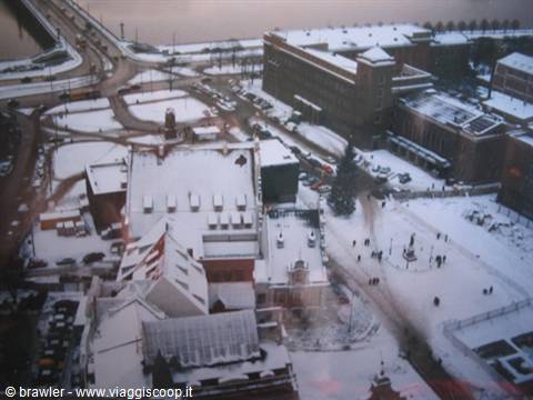 Snow-covered rooftops and square seen from above, looks like Helsinki in winter