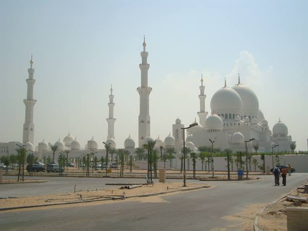 Sheikh Zayed Mosque in Abu Dhabi, white domes and minarets among palms