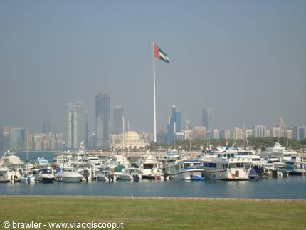 UAE flag on tall pole above Abu Dhabi marina