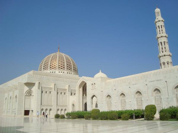Sultan Qaboos Grand Mosque in Muscat, white marble under blue sky