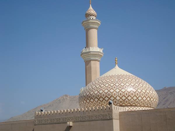 Minaret and golden dome of Sultan Qaboos Grand Mosque in Muscat